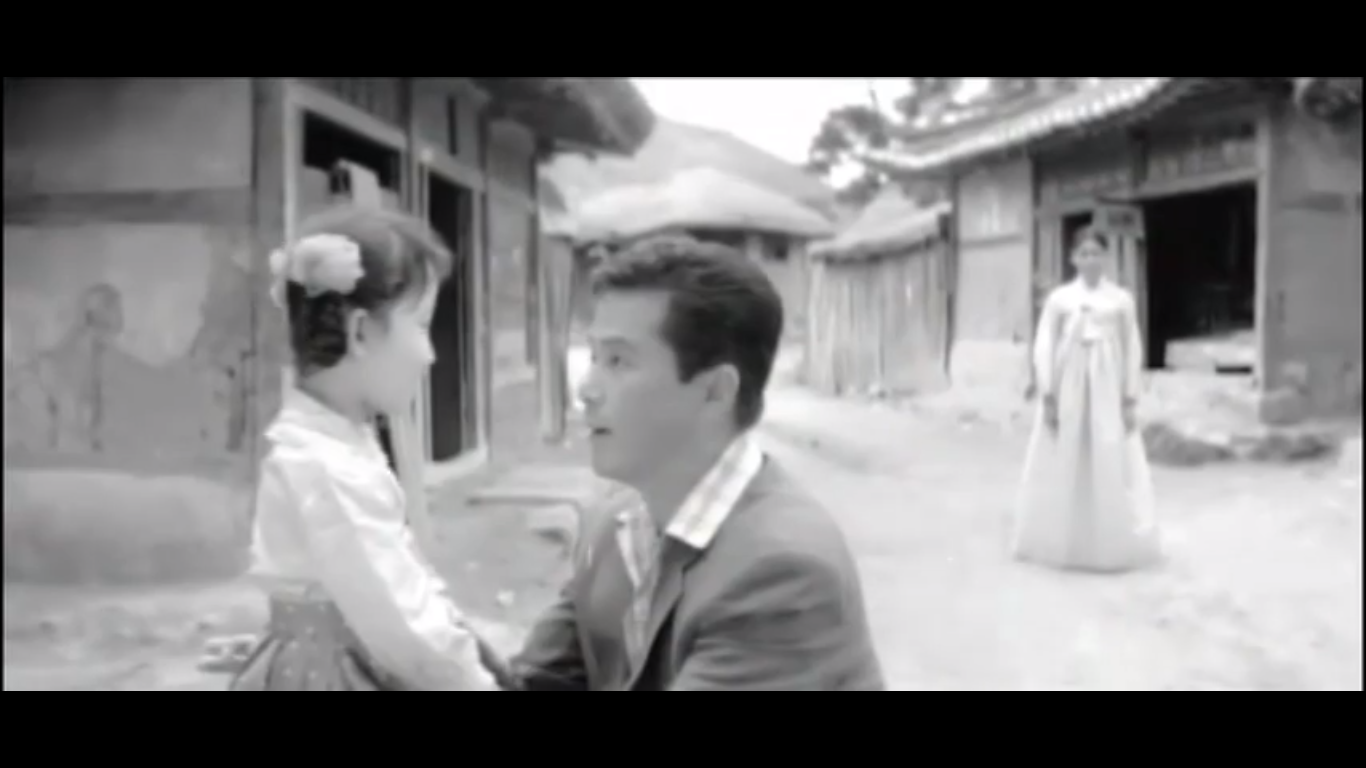 Image of Mr. Han saying goodbye to Ok-hee as Choi watches