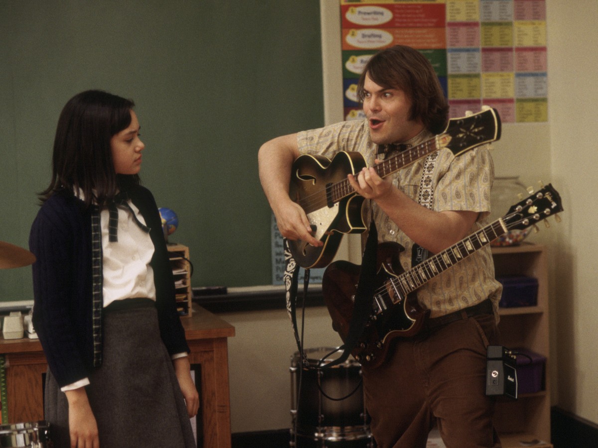 Jack Black with 2 guitars in Linklater's School of Rock